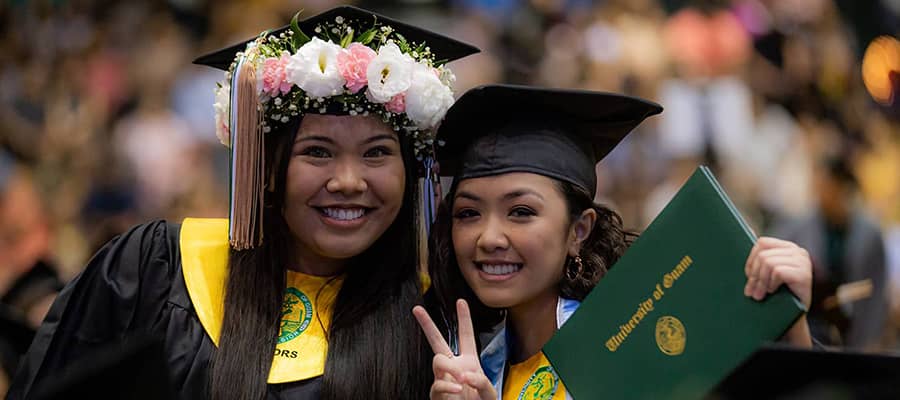 Photo of two female Triton students during commencement