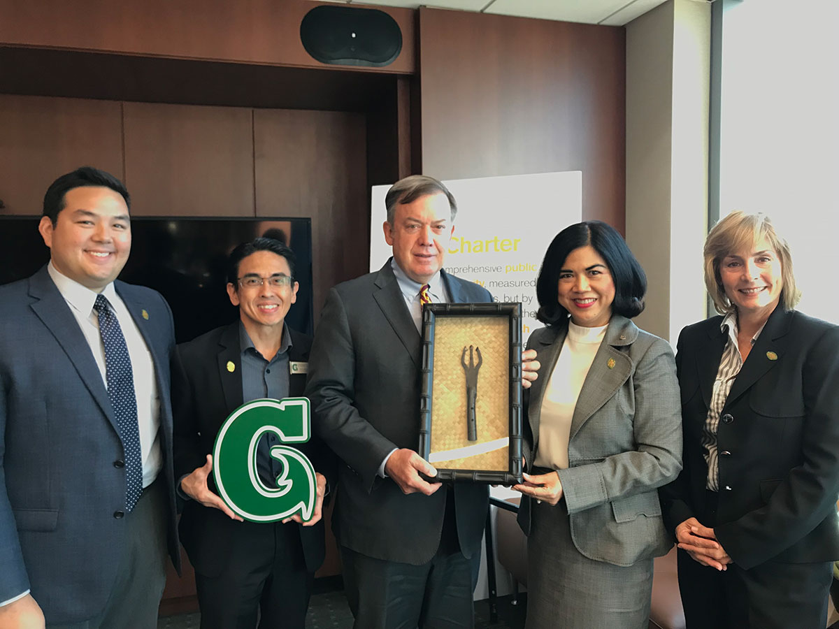  A delegation from the University of Guam presents Arizona State University President Michael M. Crow with a gift from Guam. ASU is sponsoring UOG’s Center for Island Sustainability to be a member of the Global Consortium of Sustainability Outcomes. (From left) Dr. Austin Shelton, Executive Director for UOG’s Center for Island Sustainability; Rommel Hidalgo, UOG Chief Information Officer; Crow; Dr. Anita Borja Enriquez, UOG’s Senior Vice President for Academic Affairs; and Cathleen Moore-Linn, Interim Executive Director of the Research Corporation of the University of Guam. Photo courtesy of University of Guam