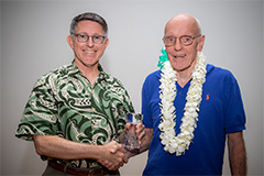 University of Guam President Thomas W. Krise presents Father Francis X. Hezel, the 37th speaker of the Presidential Lecture Serieson Jan. 22, 2019, with a gift of appreciation.