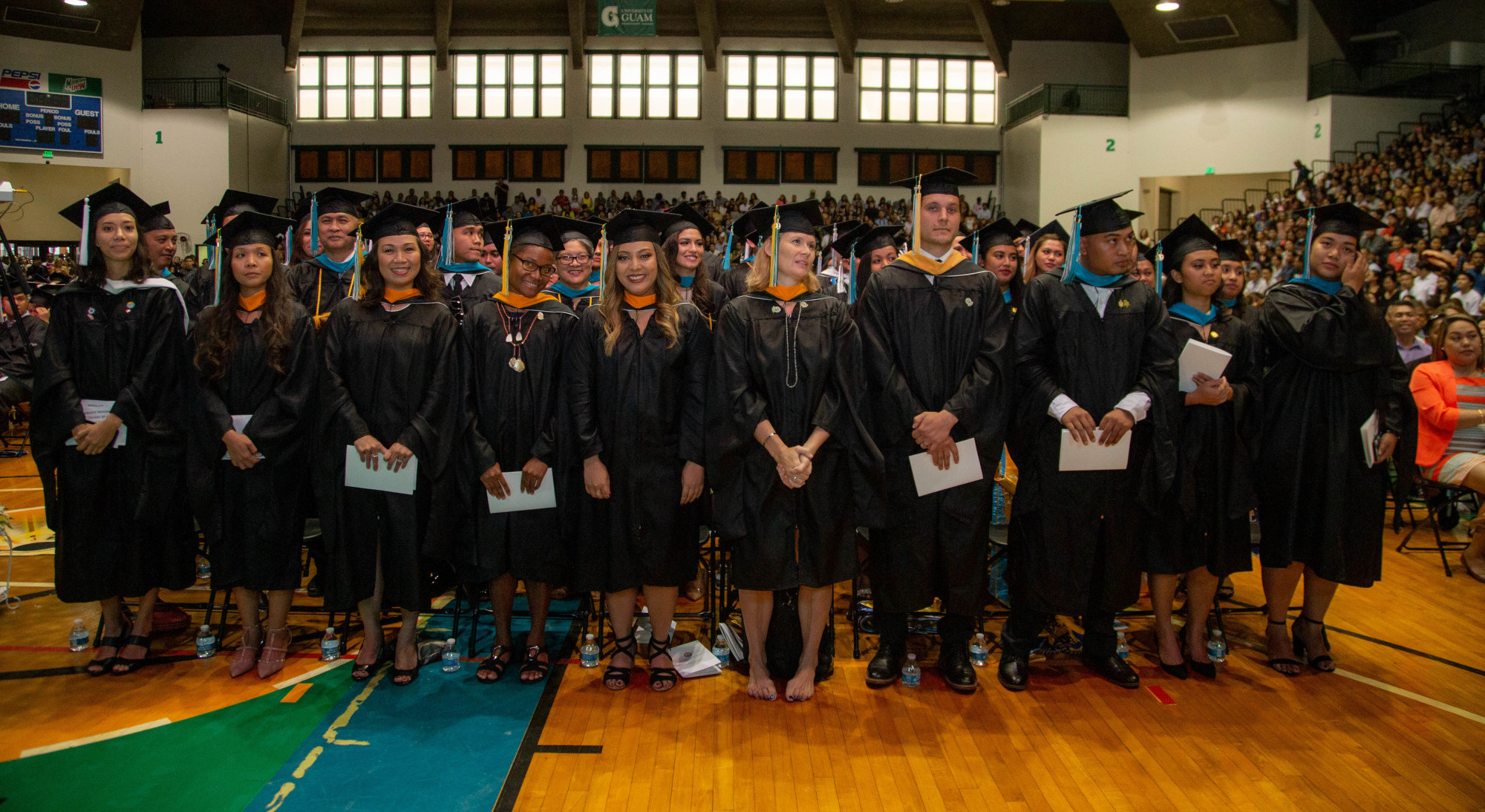 Master’s degree graduates prepare to walk across the stage. 