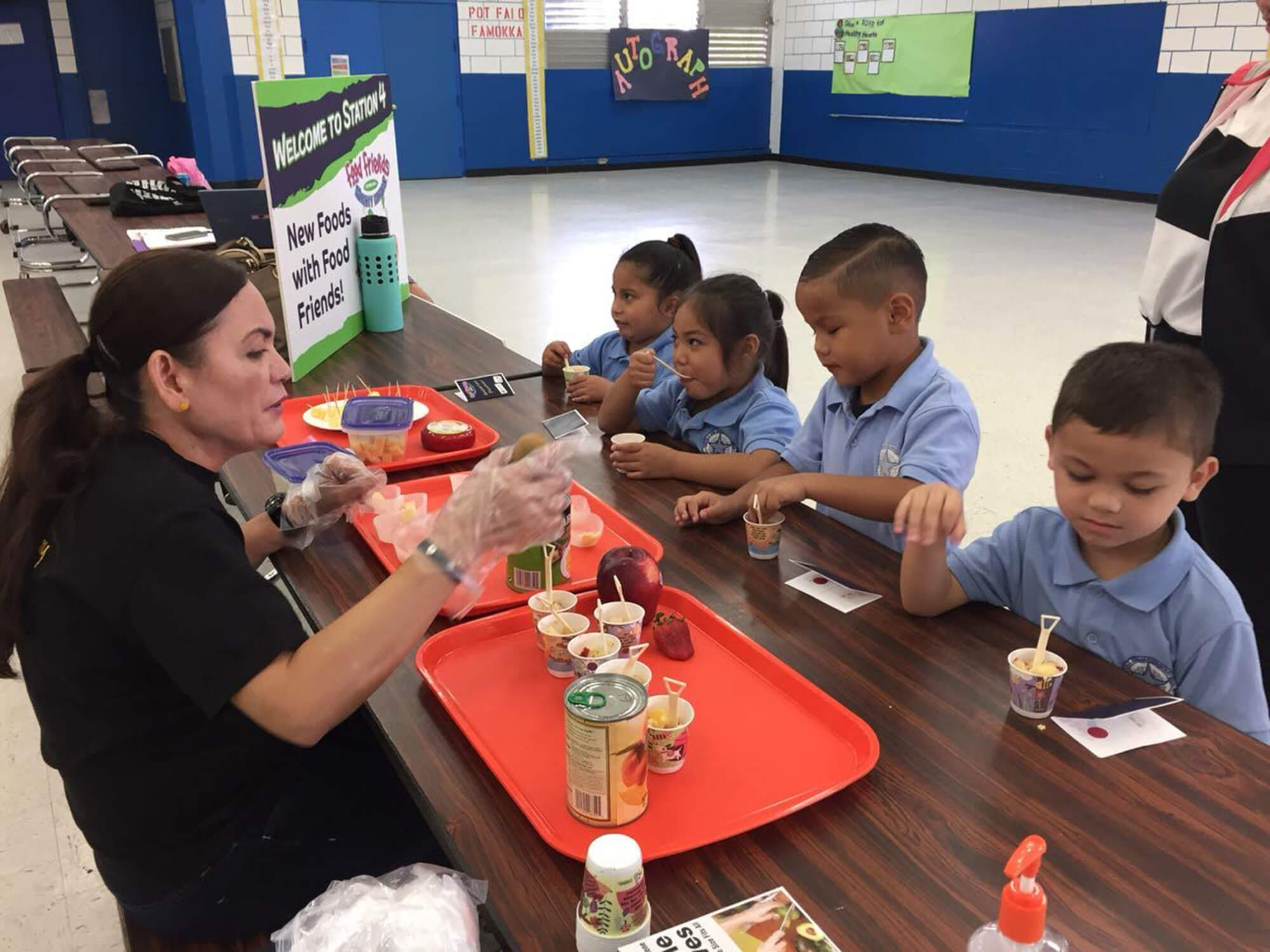 Clarissa Barcinas preparing food portions for children as part of the "Food Friends" program.