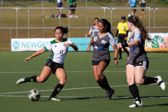 UOG's Ariya Cruz, No. 9, moves the ball upfield against two opponents. Cruz scored two of UOG's six goals in the March 10 match.