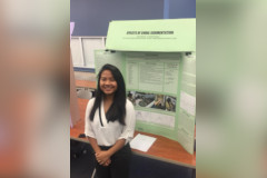 Kiara Dela Rosa poses in front of her science fair project