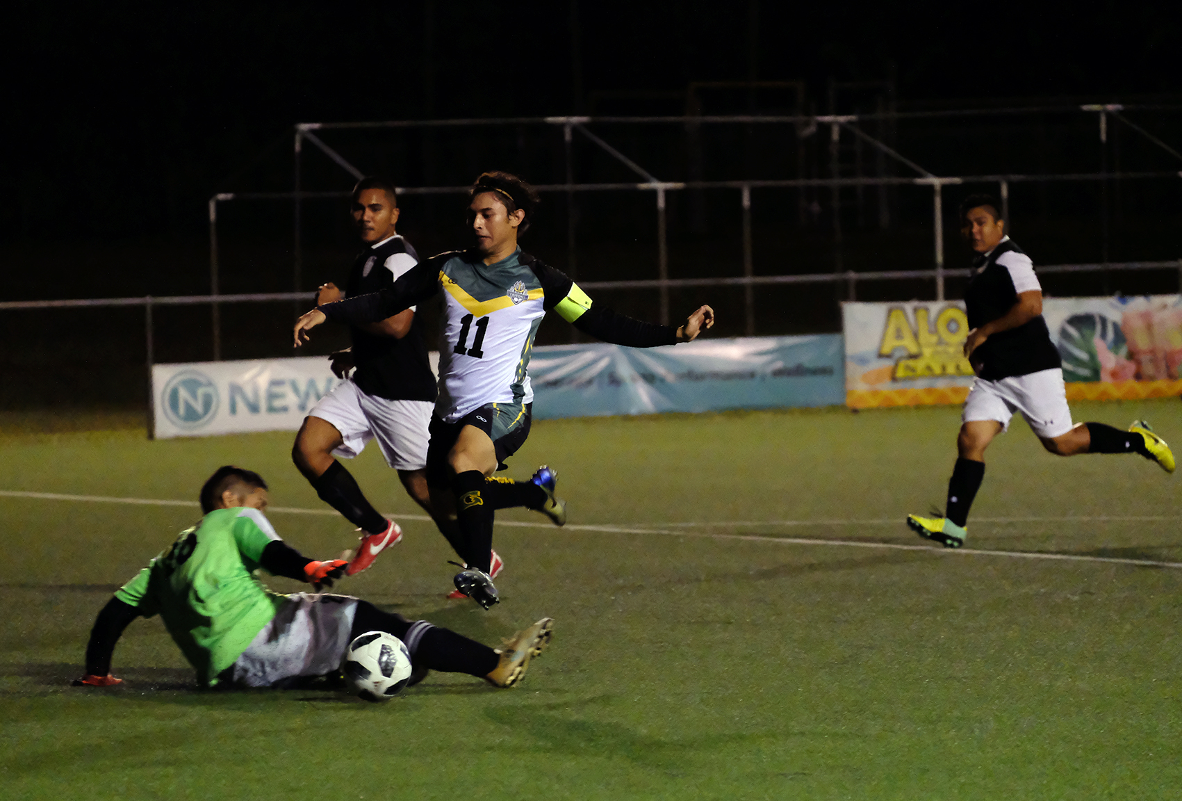 UOG's Dylan Naputi drives by the goalkeeper for a score