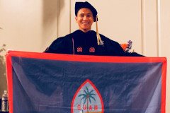 Mark Vincent Yu holding the Guam flag