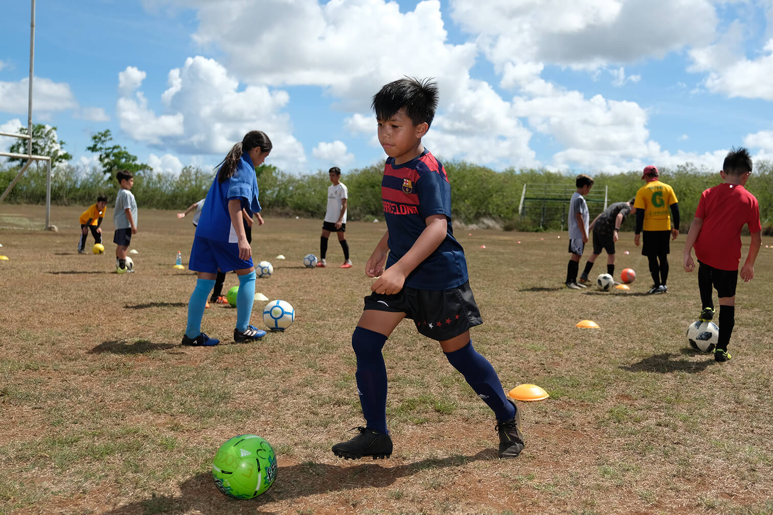 Camper performs soccer drills