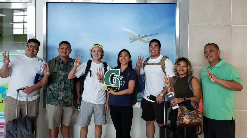 Six students prepare to board the plane to korea