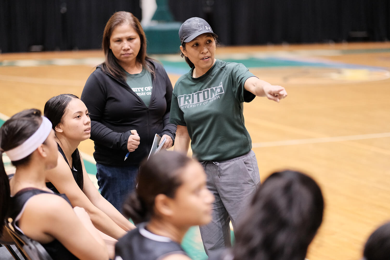  UOG Head Coach Cecile Olandez gives the Tritons direction at halftime.
