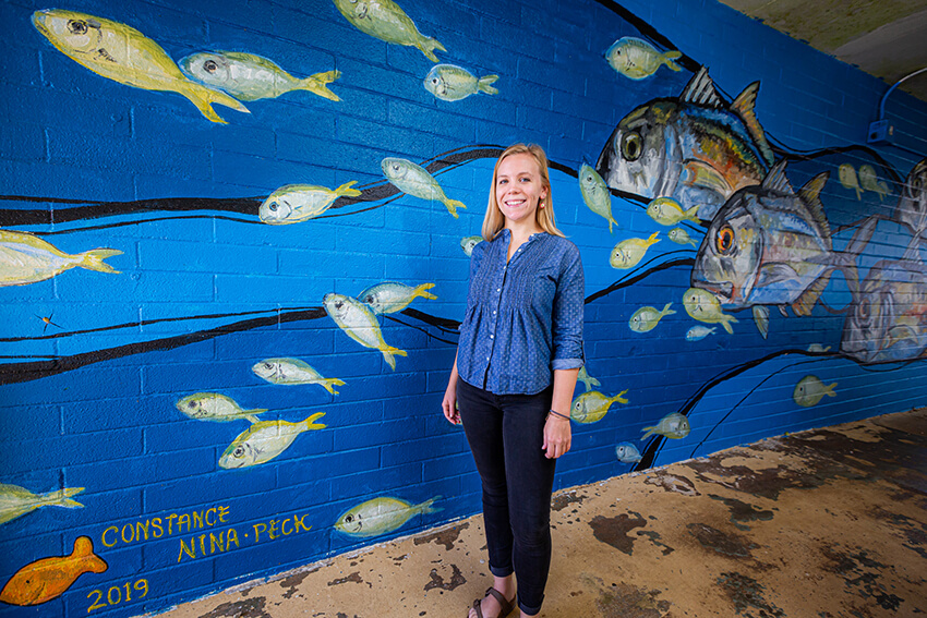 Sartor painted a mural in an outdoor hallway at the Marine Lab along with graduate student Nina Peck