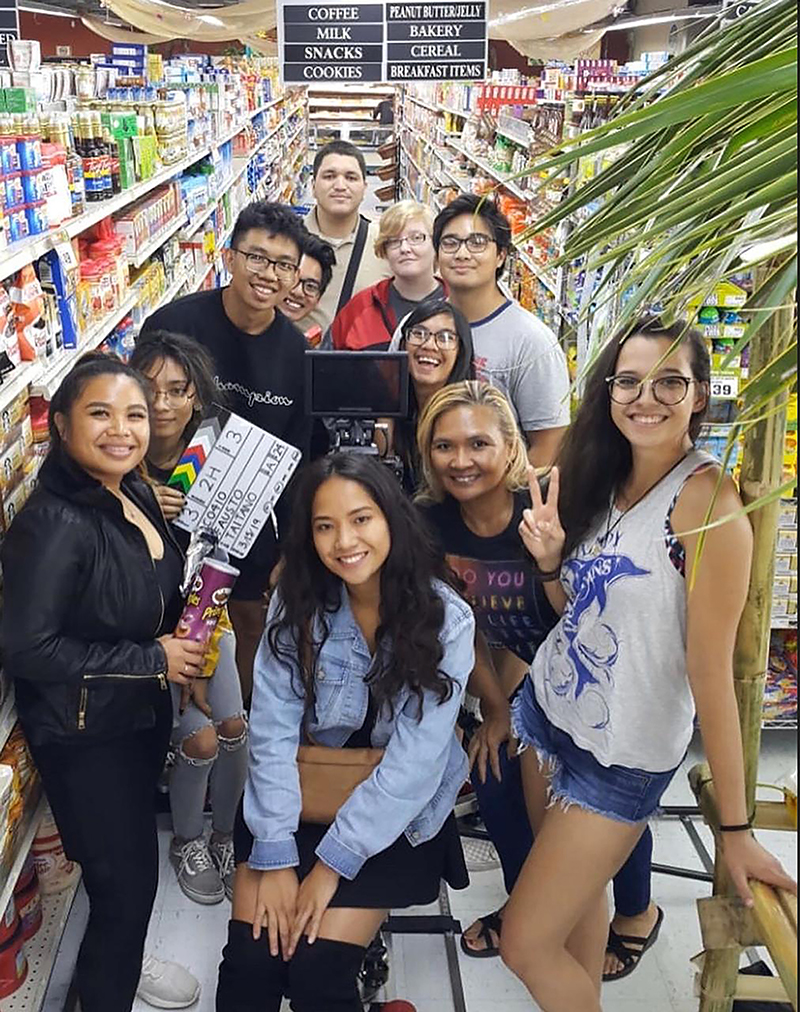 The cast and crew of “Left on Read” pause the filming of a grocery store scene 