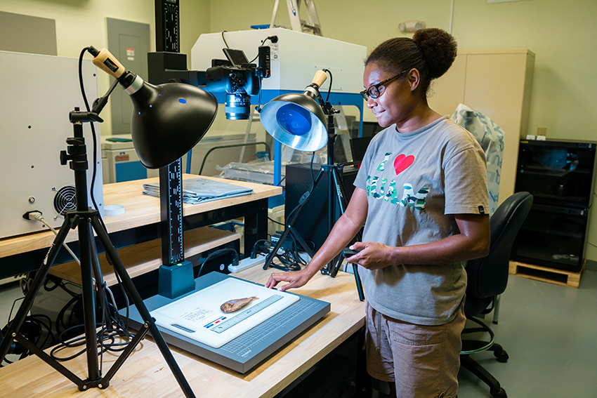 Mildred Kelokelo, a grad biology student at UoG, documents a reef fish