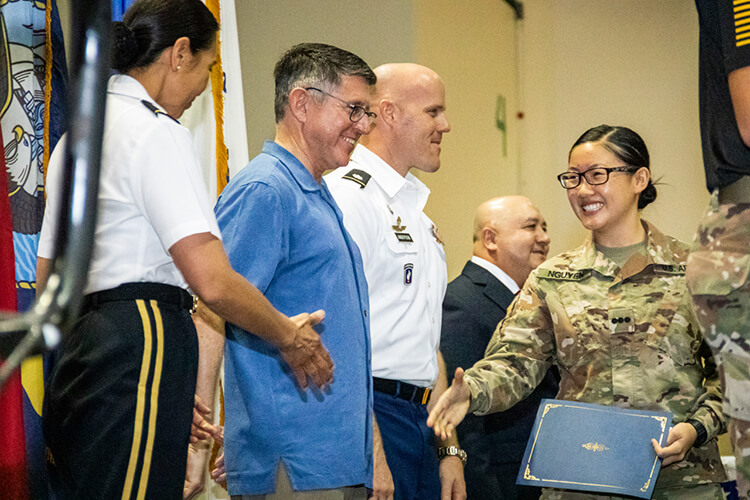 Jeanie Nguyen, a cadet in UOG's ROTC program, shakes hands at a Veterans Day ceremony on Nov. 12