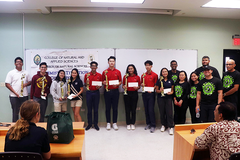 The winners of the University of Guam’s high school Chemistry Titration Competition on March 10. (From left) Isaiah Alvendia and Brian Songco, Father Dueñas Memorial School; Jaimie Adrienne Paunte and Nicole Jean Pineda, St. Paul Christian School; Chanyoung Lee, Brian Joseph, Grace Hutapea, and Matthew Zhang, St. John’s School; Megan Lopez, Harvest Christian Academy; Associate Professor Tedros Bezabeh; Assistant Professor Bulan Wu; Karla Wang, laboratory supervisor; Assistant Professor John Limtiaco; Jason Pangelinan, laboratory technician; and Professor Maika Vuki.