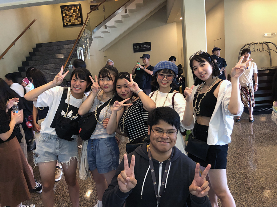 UOG student with Otakanomori High School students posing for a picture.