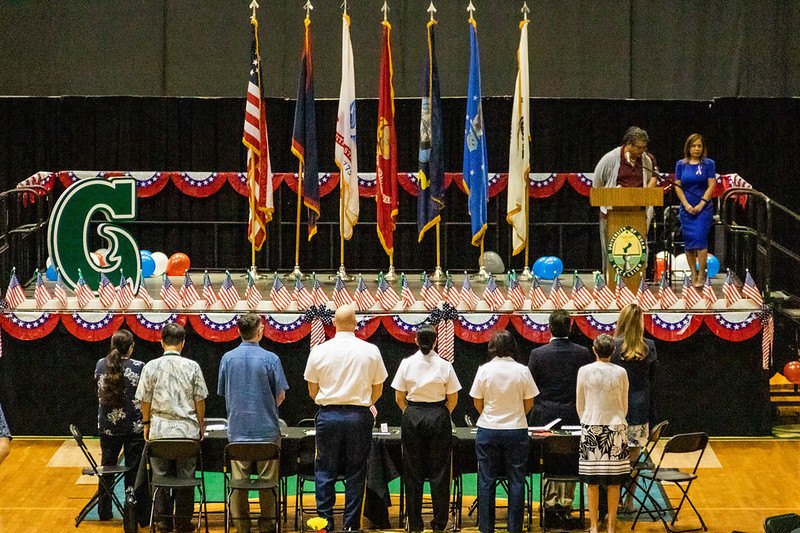 University administrators stand for the anthem