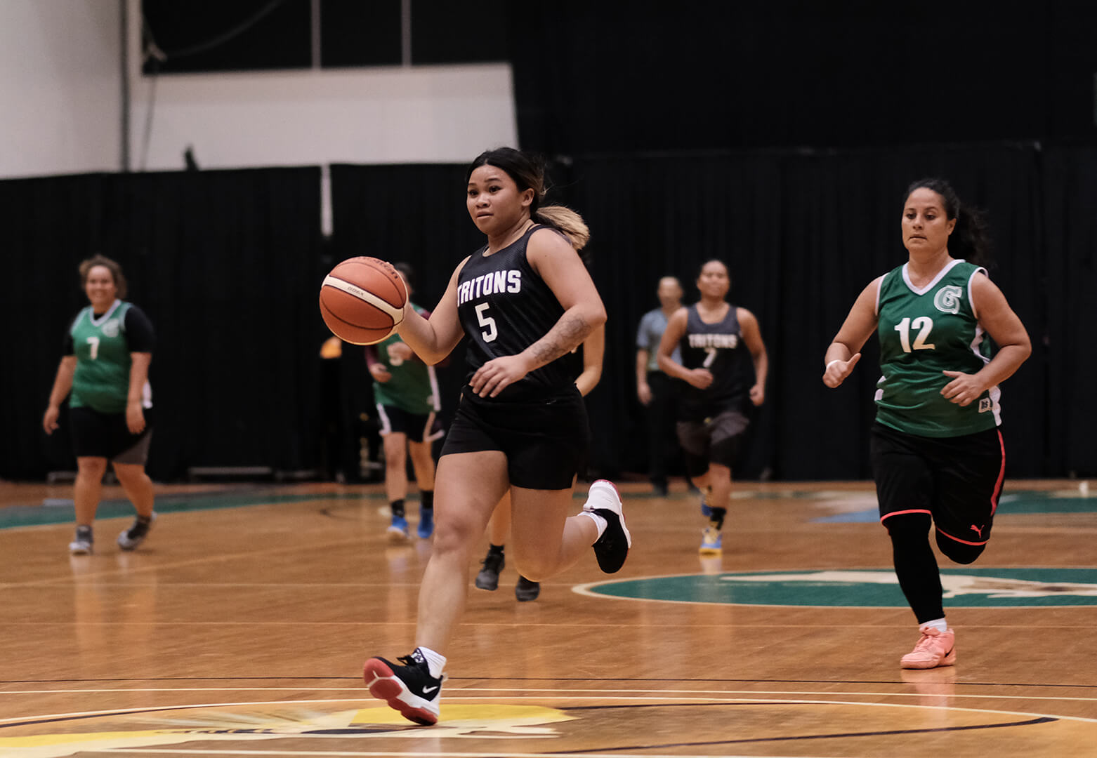 Bulala Shania leads a fast break for the UOG Tritons.