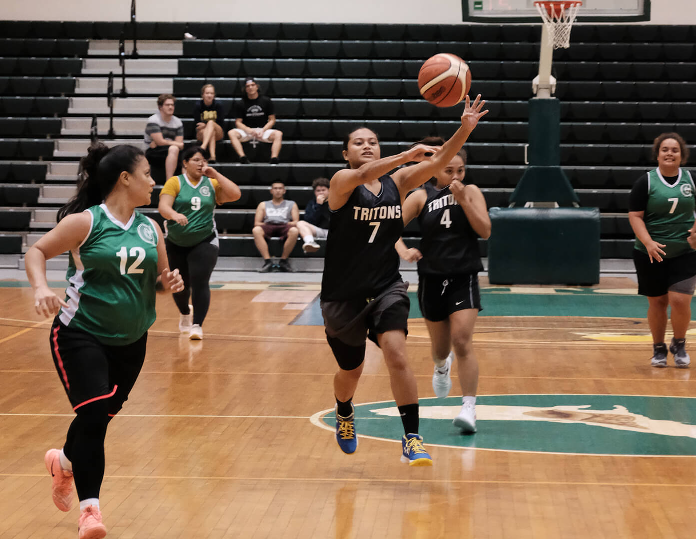 The Tritons' Jacether Andrew, No. 7, passes the ball.