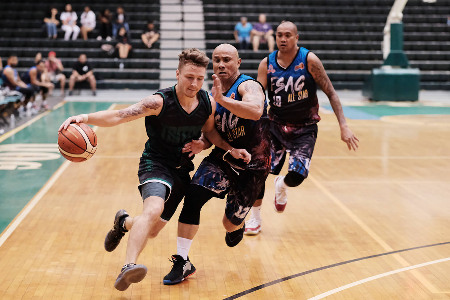 UOG's Logan Hopkins dribbles past the FSAG All-Star defense 