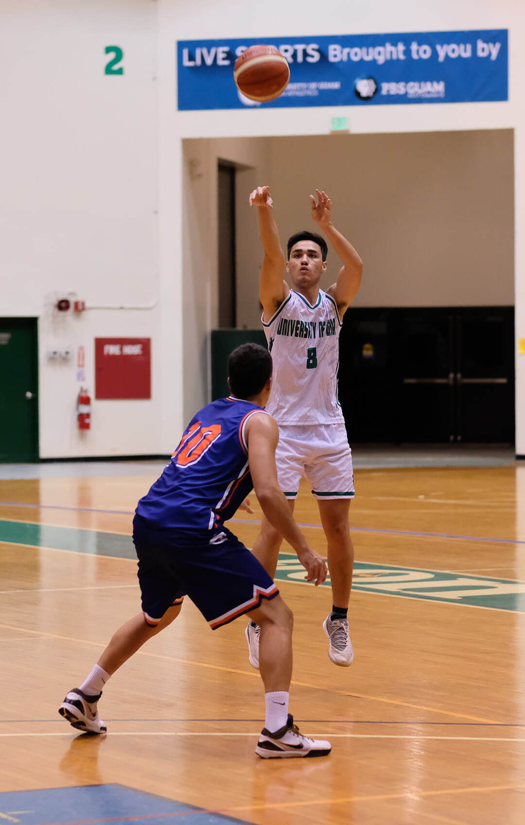 Michael Quan scores a 3-point basket for the Tritons.