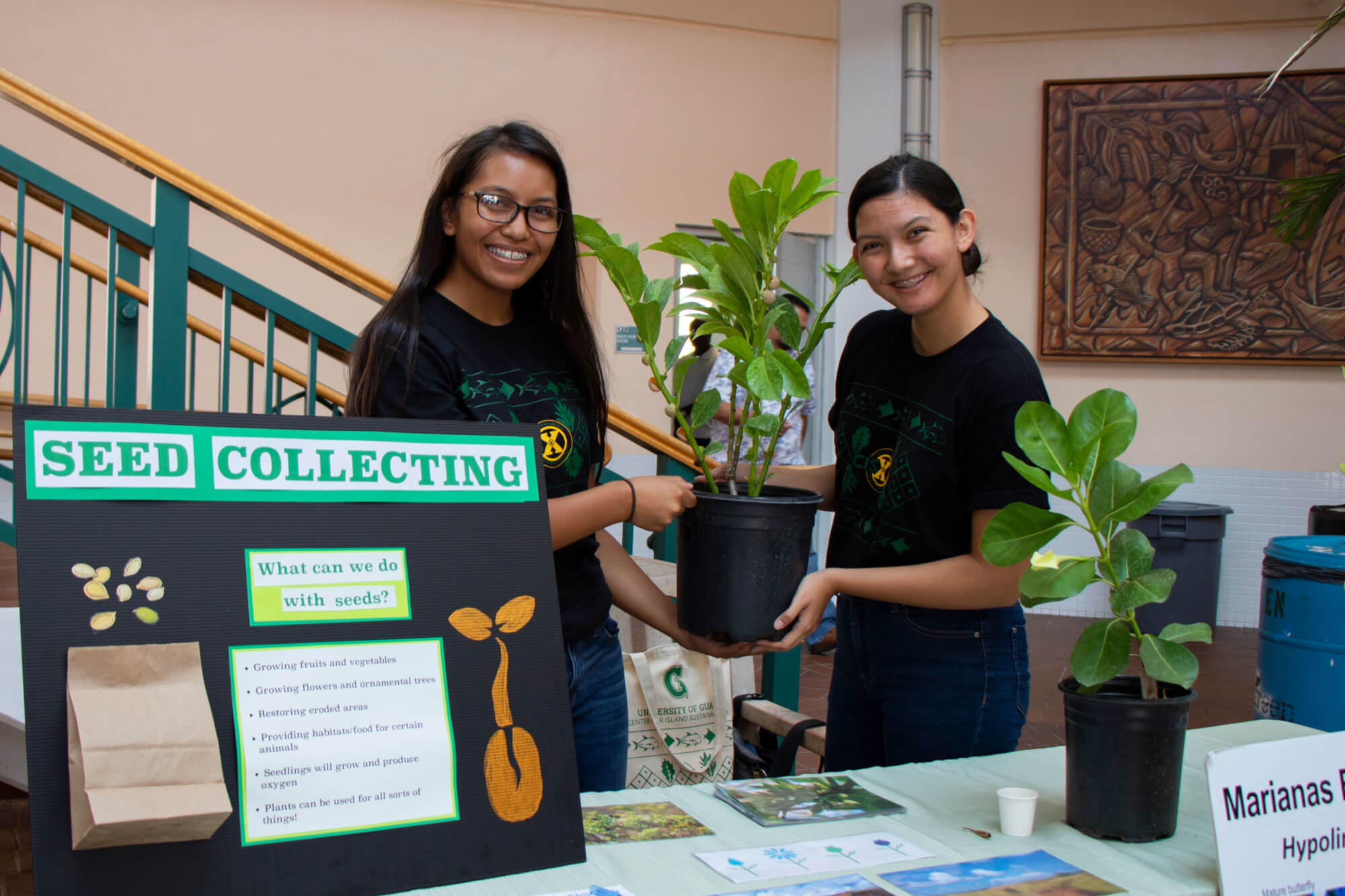 (From left) Alyssa Taitano and Laura Gombar, display their seed collecting booth