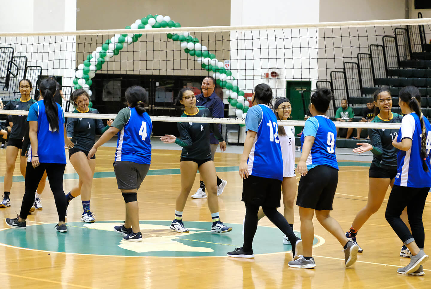 Tridents club team shakes hands with the Tritons varsity team