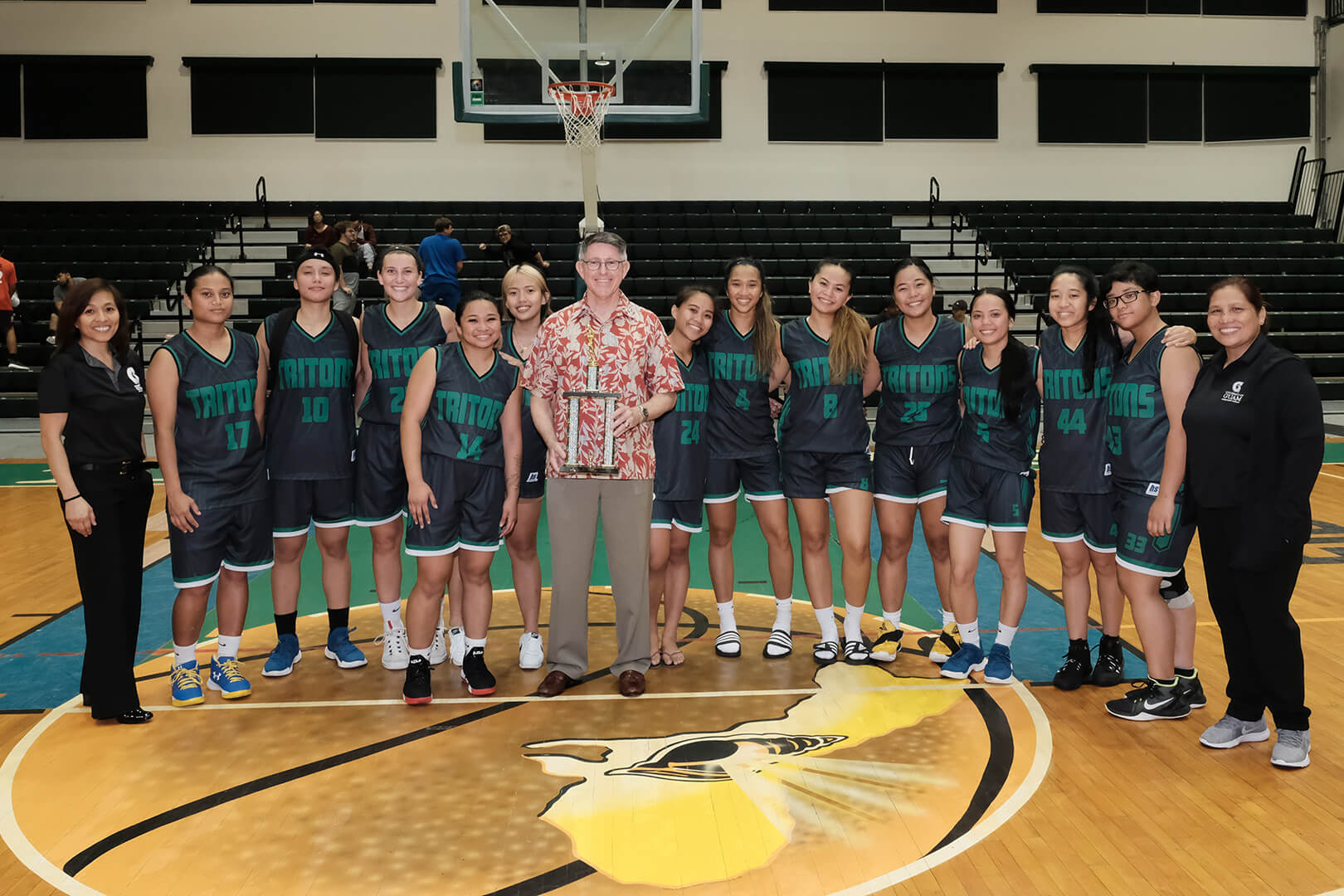 UOG Triton Women’s Basketball Team celebrate a strong season with UOG President Thomas W. Krise.