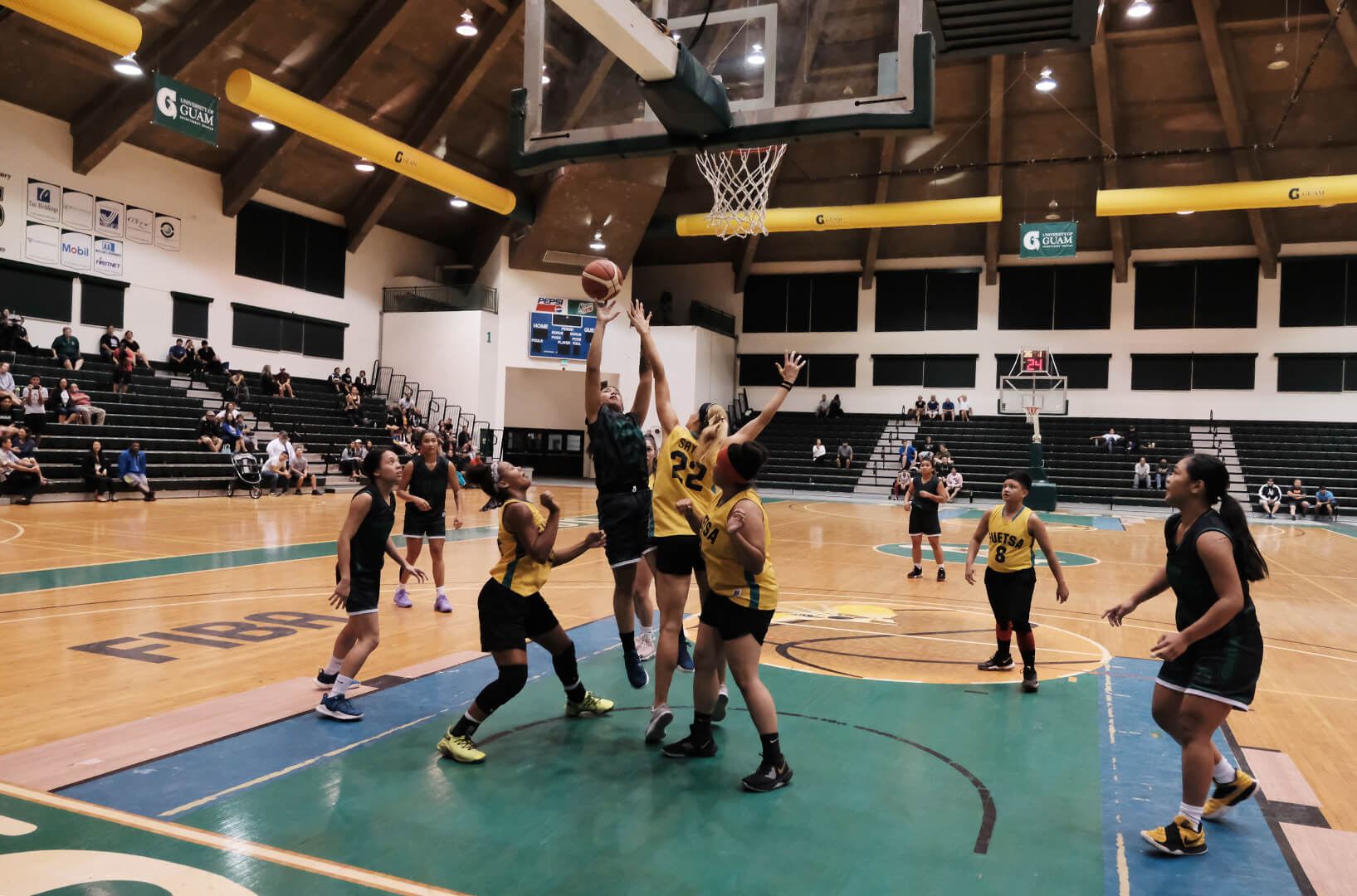 Niah Siguenza of the UOG Tritons goes up for a two-point basket against her opponent.