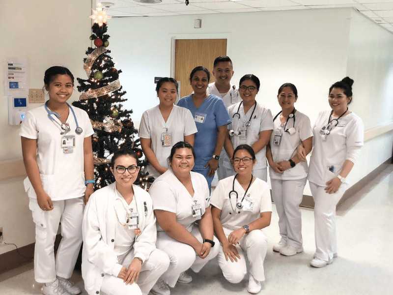 Group photo of Reggie Mae Dionisio with fellow nursing classmates and their professor