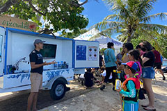 Phil Cruz gives a lesson from the Tasi Outreach Trailer