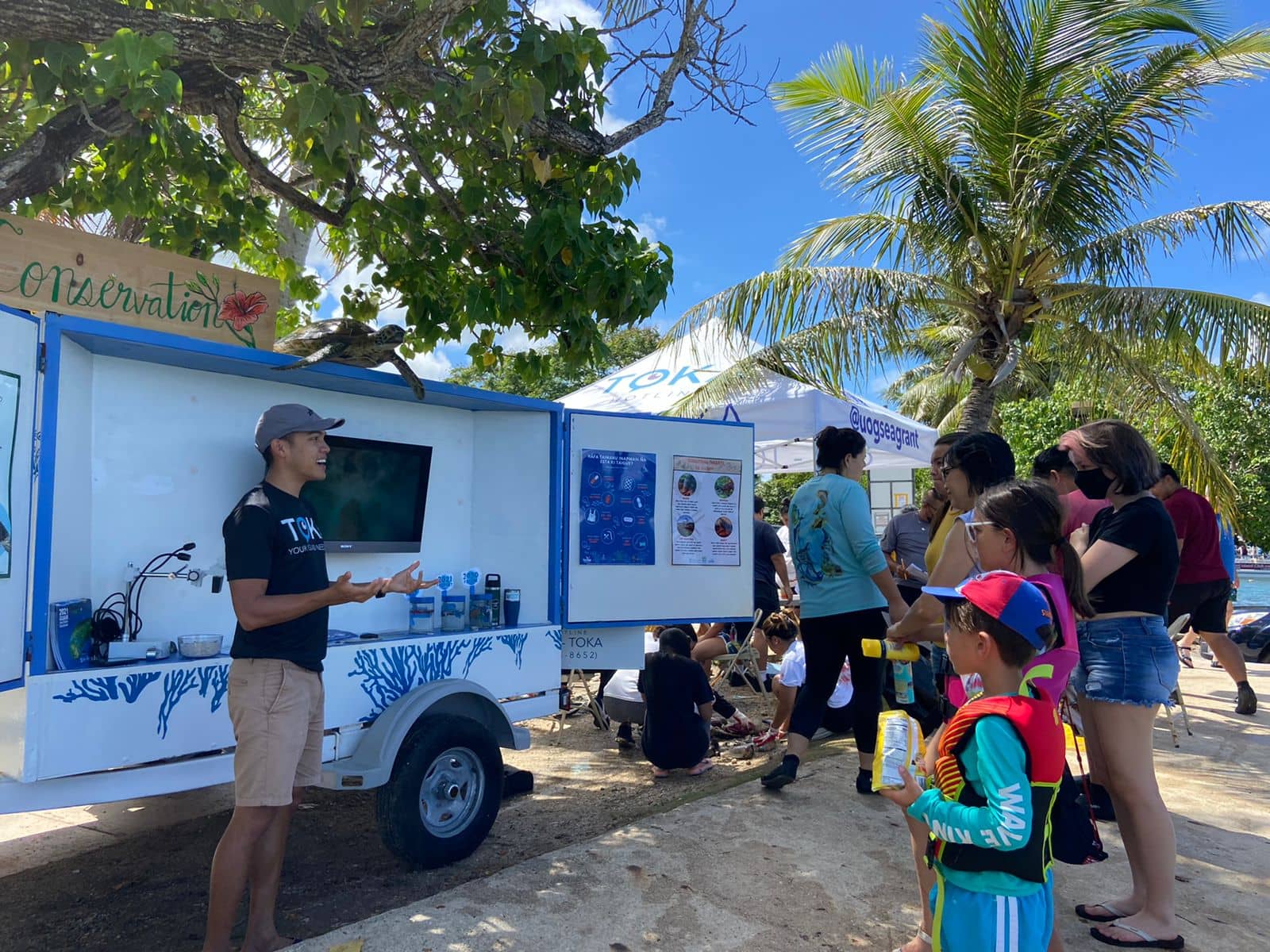 UOG Sea Grant Outreach Coordinator Phil Cruz gives a lesson from the Tasi Outreach Trailer 