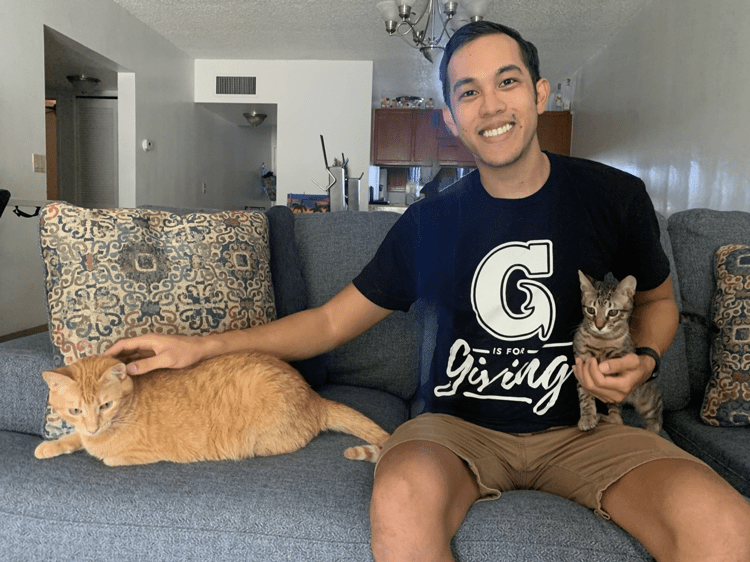 Sustainability Coordinator Phil Cruz with his two cats, Maury and Jeffrey.