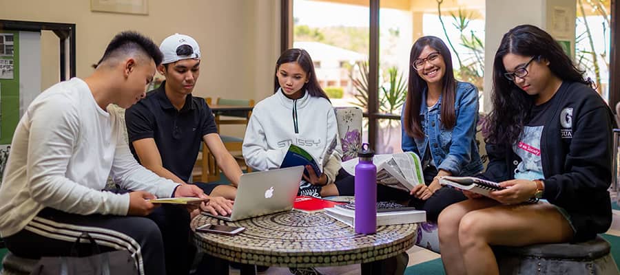 A group photo of students working on a group project