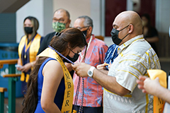 Lt. Gov. Joshua Tenorio places honor cord on graduating senior Ivana Sherell Nimea.