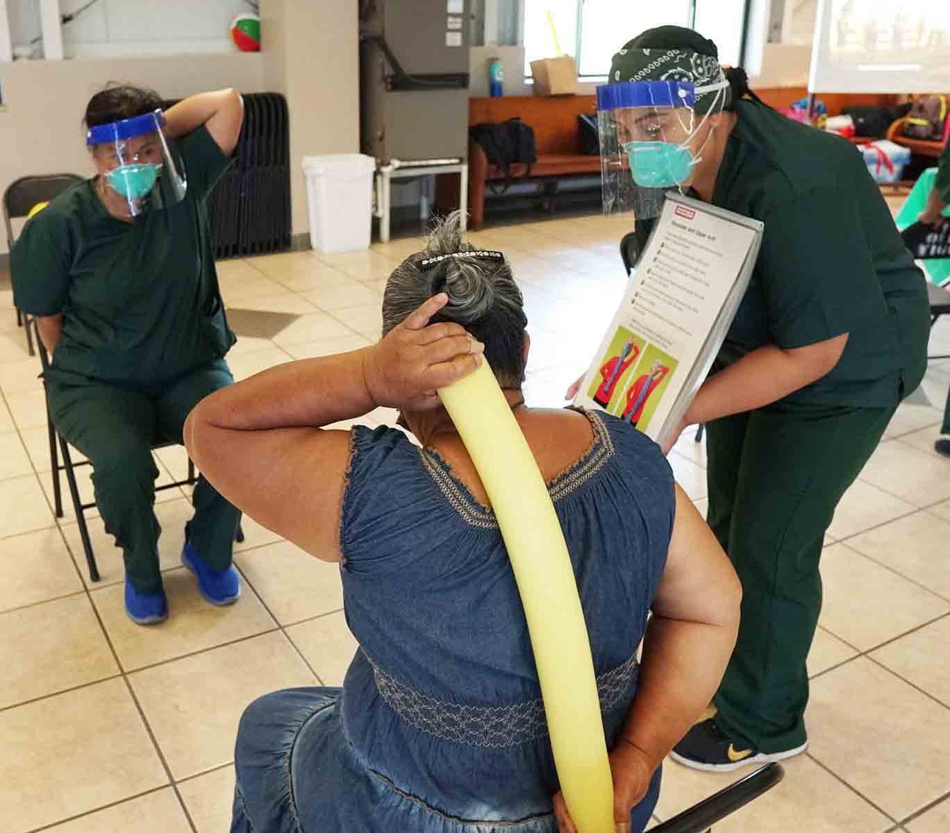 Staff assist a resident with mobility exercises