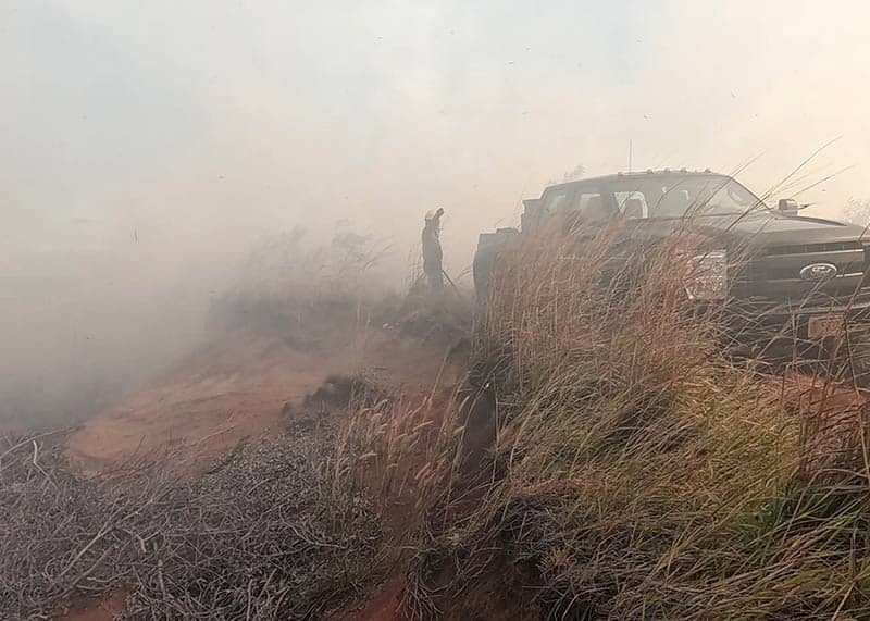 Photo of smoke from a fire in Merizo engulfs a truck