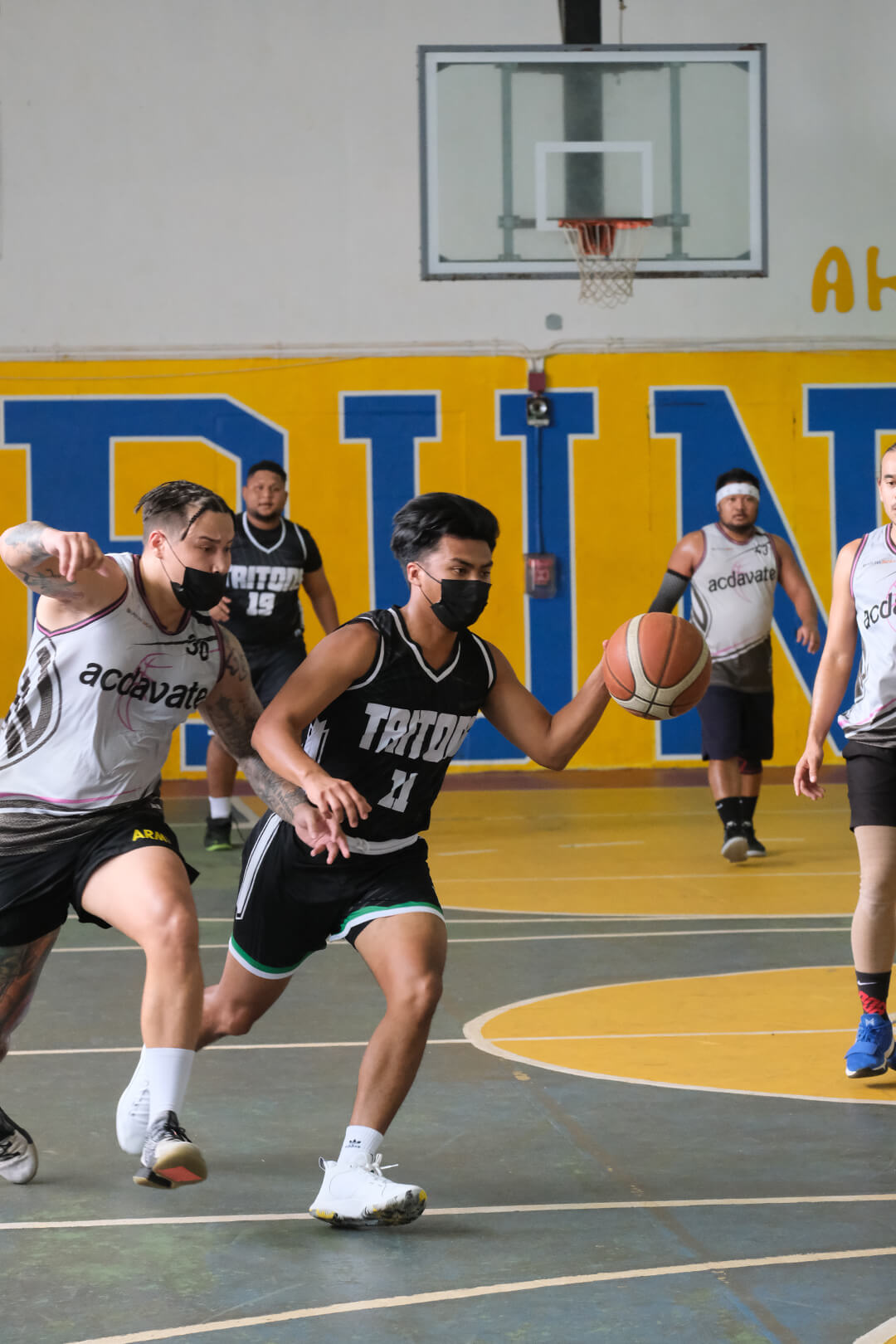 Players running up basketball court