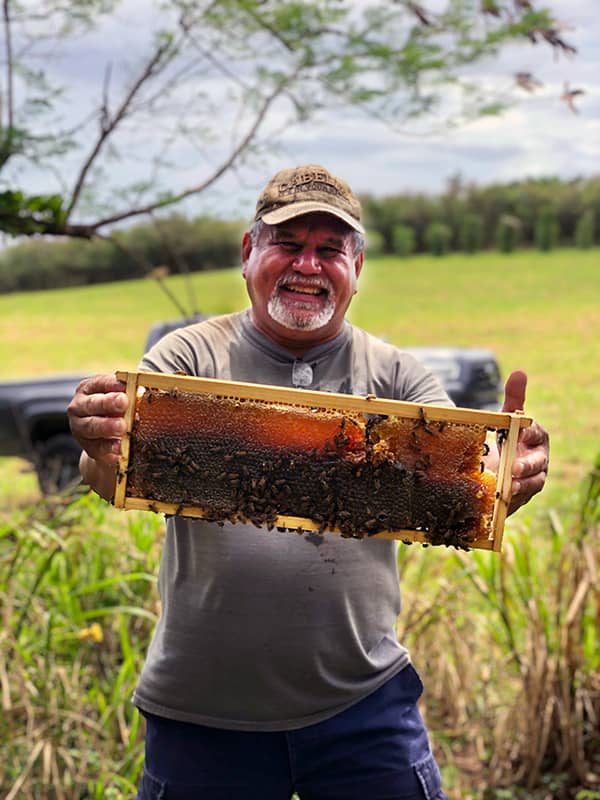 Mike Aguon holding a honeycomb