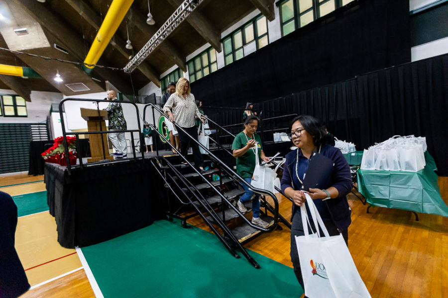 Some of the recognized employees take turns receiving certificates during the Triton Awards Program Nov. 30 at the Calvo Field House.