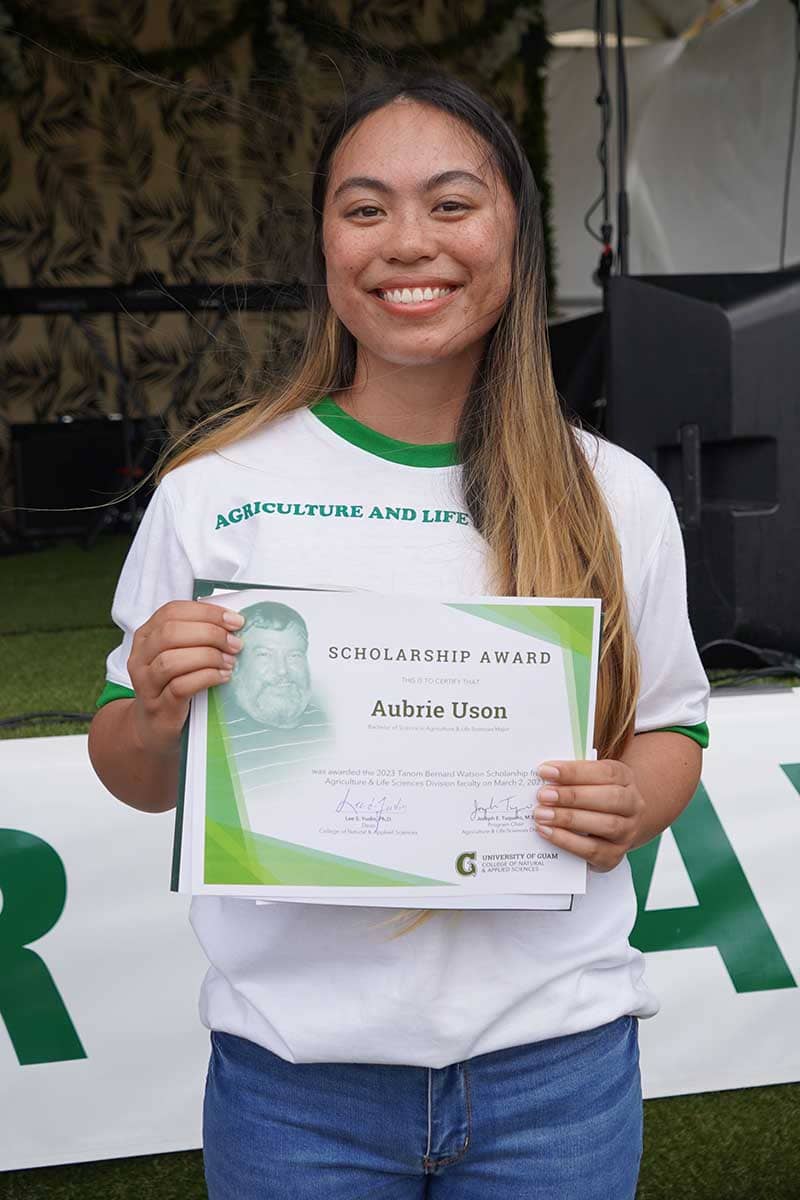 Aubrie Uson poses for a photo with her scholarship award certificate