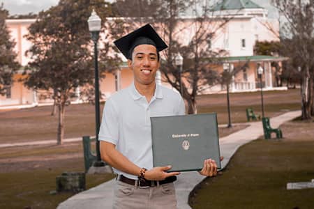 UOG student poses outdoors with Bachelor’s Degree