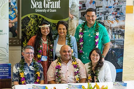 Conference on Island Sustainability guest speaker and members posing for a photo