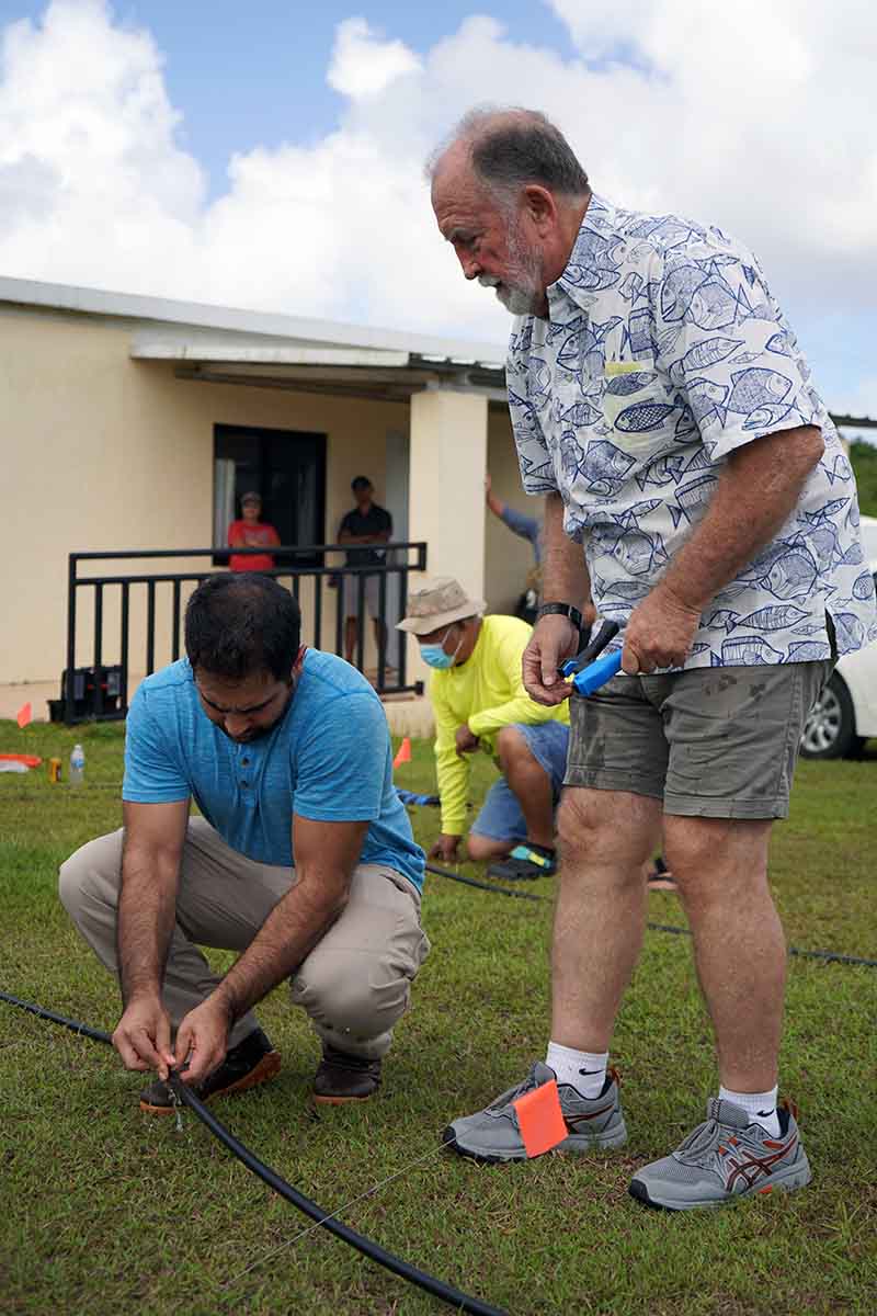 Photo of Robert Bevacqua guiding a participant of the Drip Irrigation Workshop.