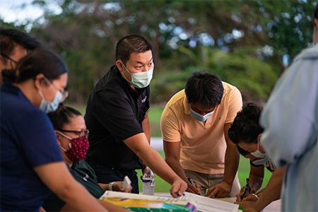 Dr. Kuan-Ju Chen of the University of Guam hands out stress surveys to Guam farmers in 2021.
