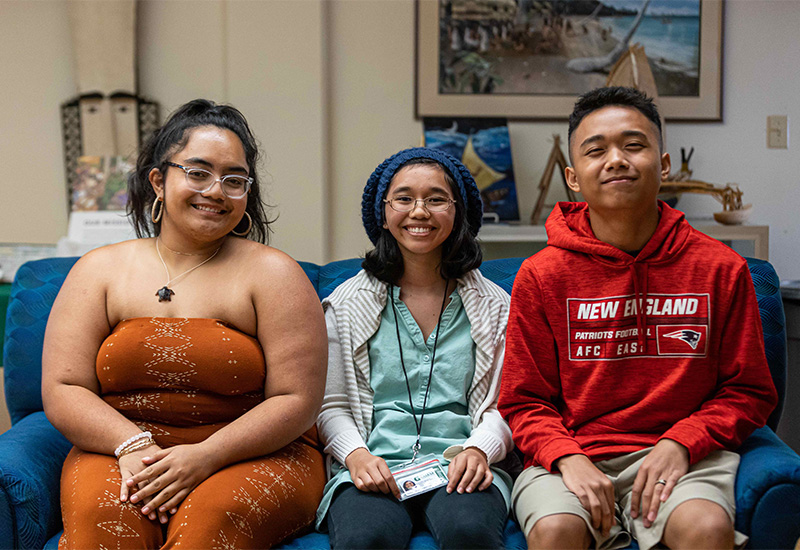 Three interns pose for photo at Micronesian Area Research Center.