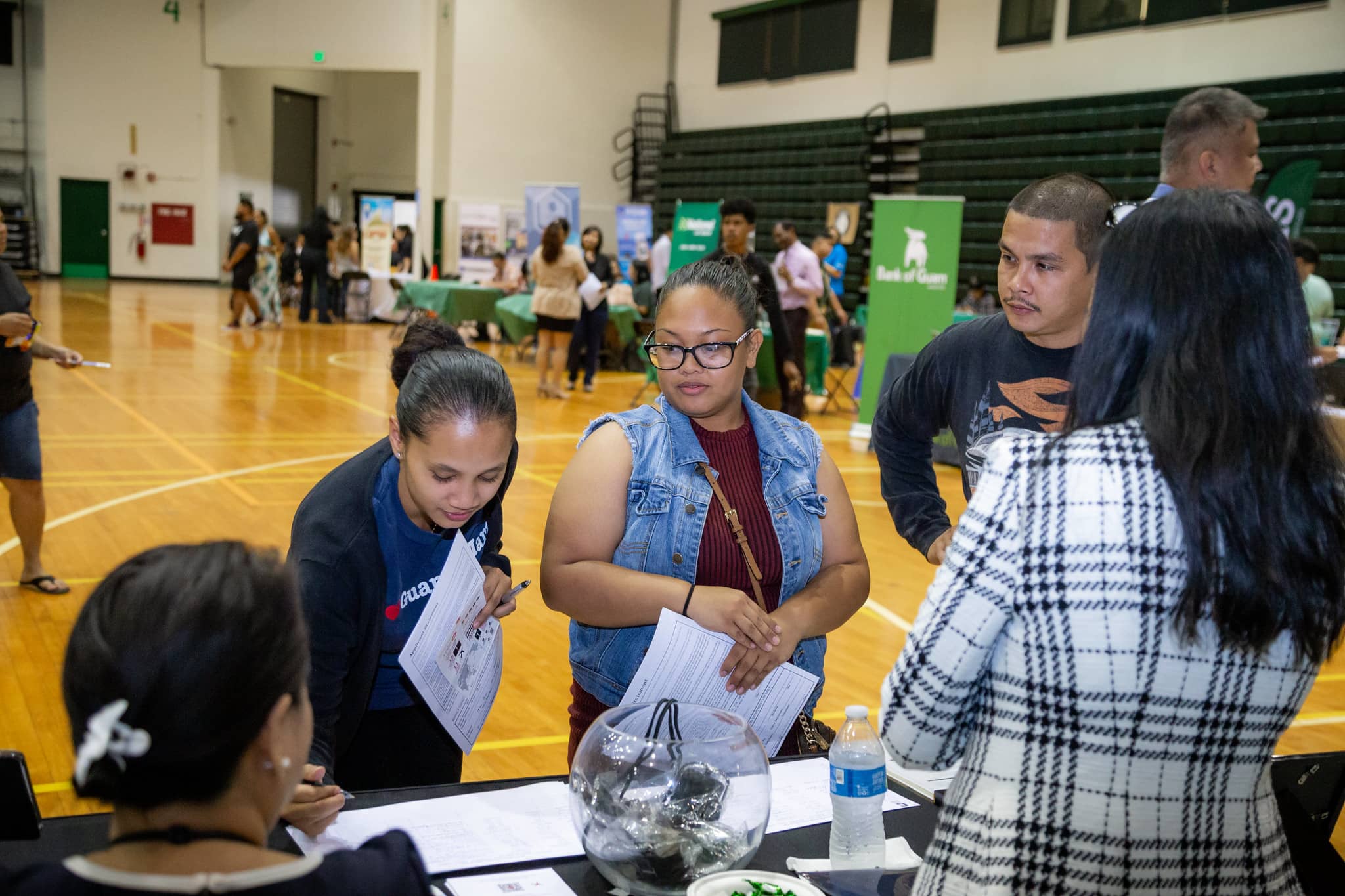 Job seekers check out an employer's table during a  job fair at the University of Guam Calvo Field House in 2019. Another job fair, scheduled for April 28, will have more than 50 employers participating.