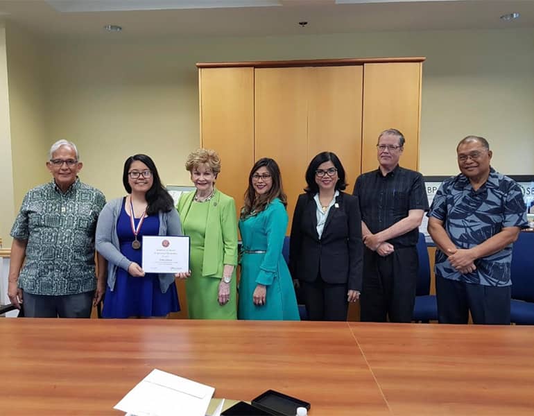 Maria Dolman poses for photo with several of her mentors in 2018, receiving a congressional medal.