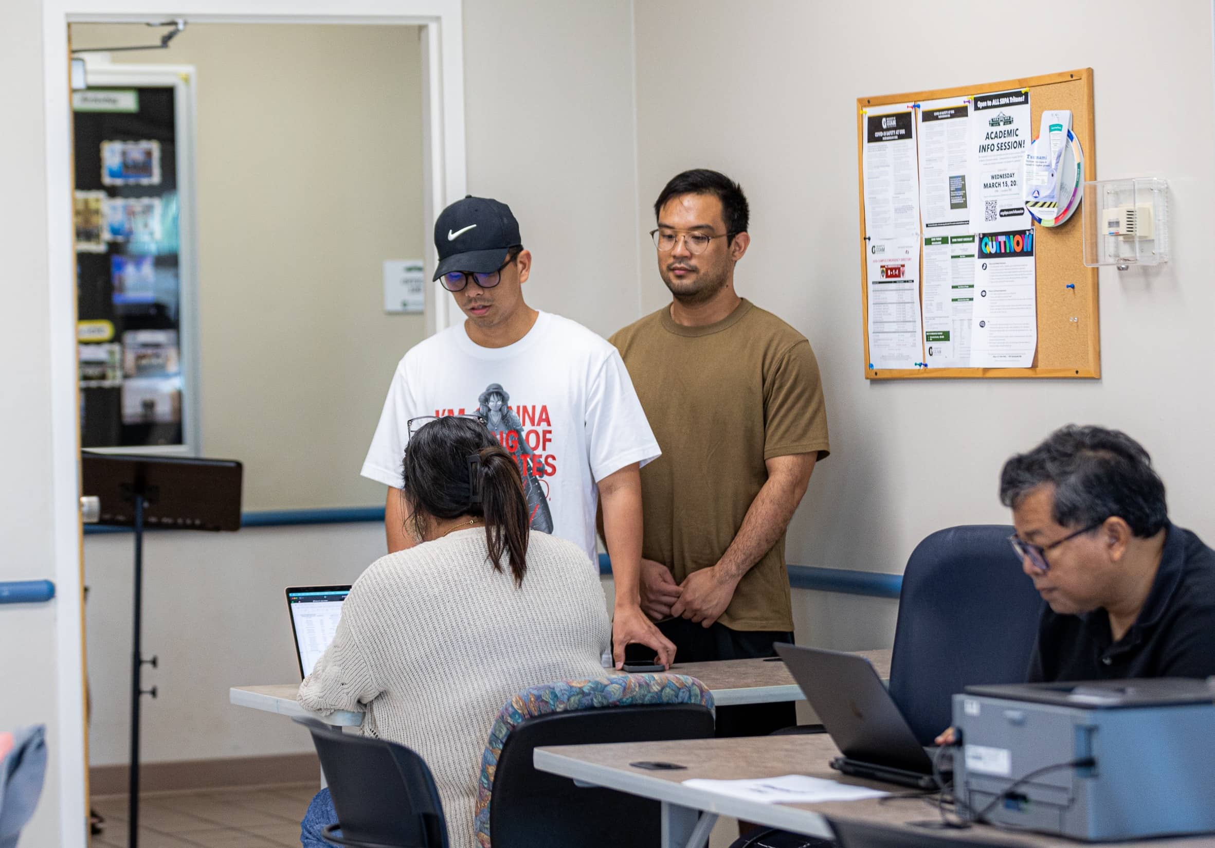 Two students checking in at the one-stop for student services