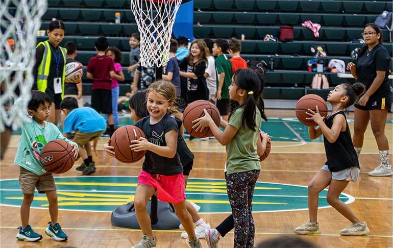 Children play basketball during Triton Athletic Sports Camp