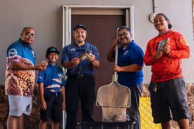 Sea Grant staff and Mangilao Vice Mayor with harvested tilapia