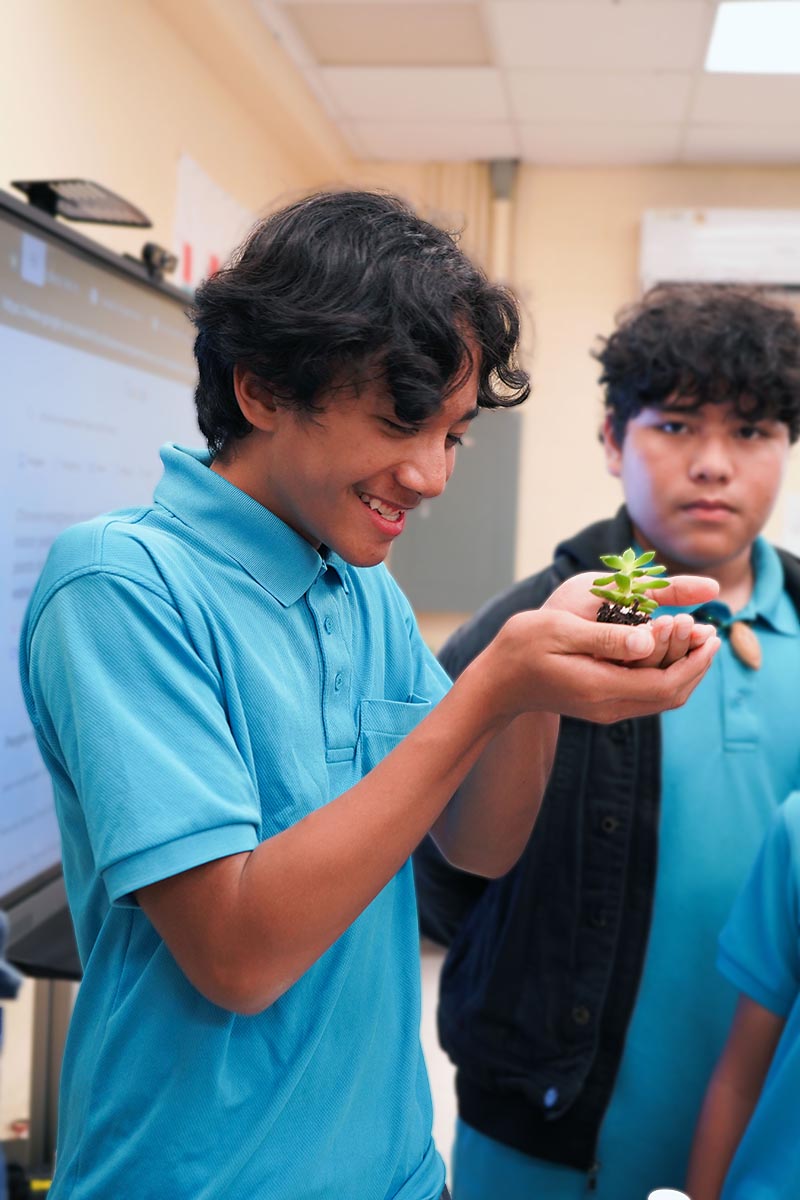 Photo of Guåhan Charter Academy student Bourne Procalla holding a succulent